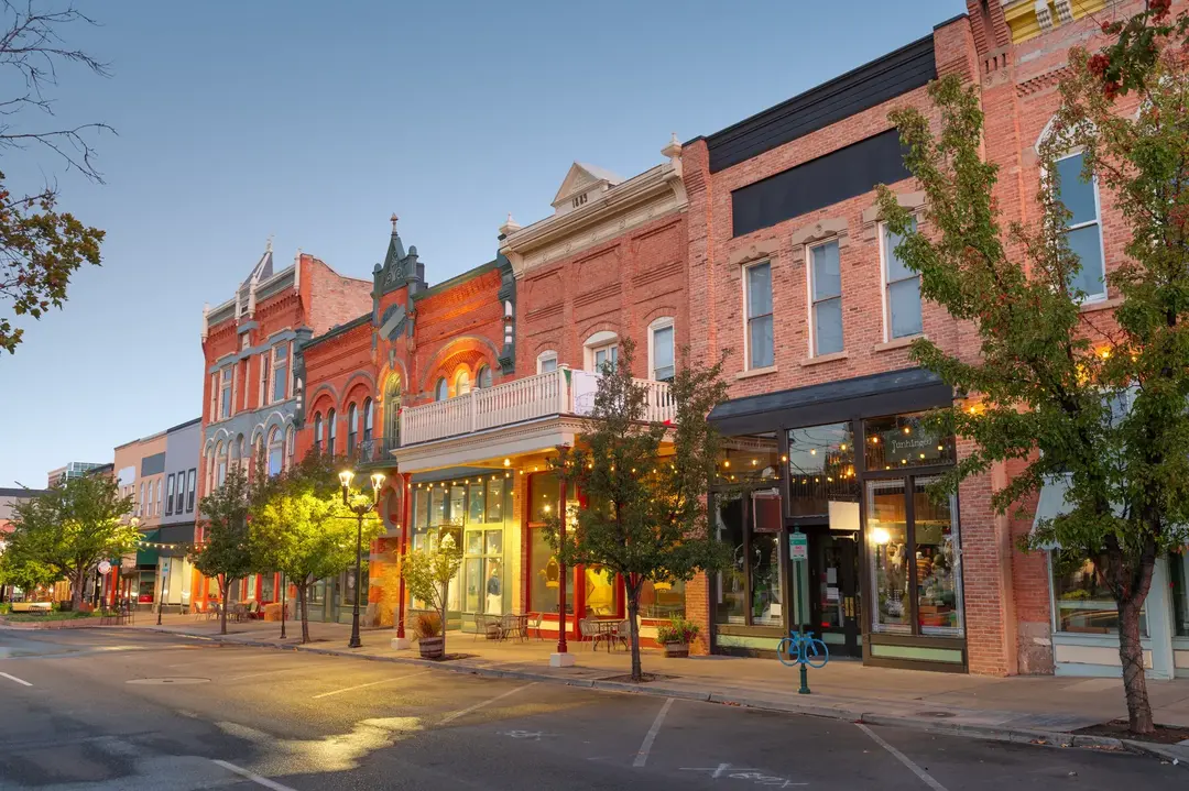 Historic brick Main Street storefronts with apartments above at dusk